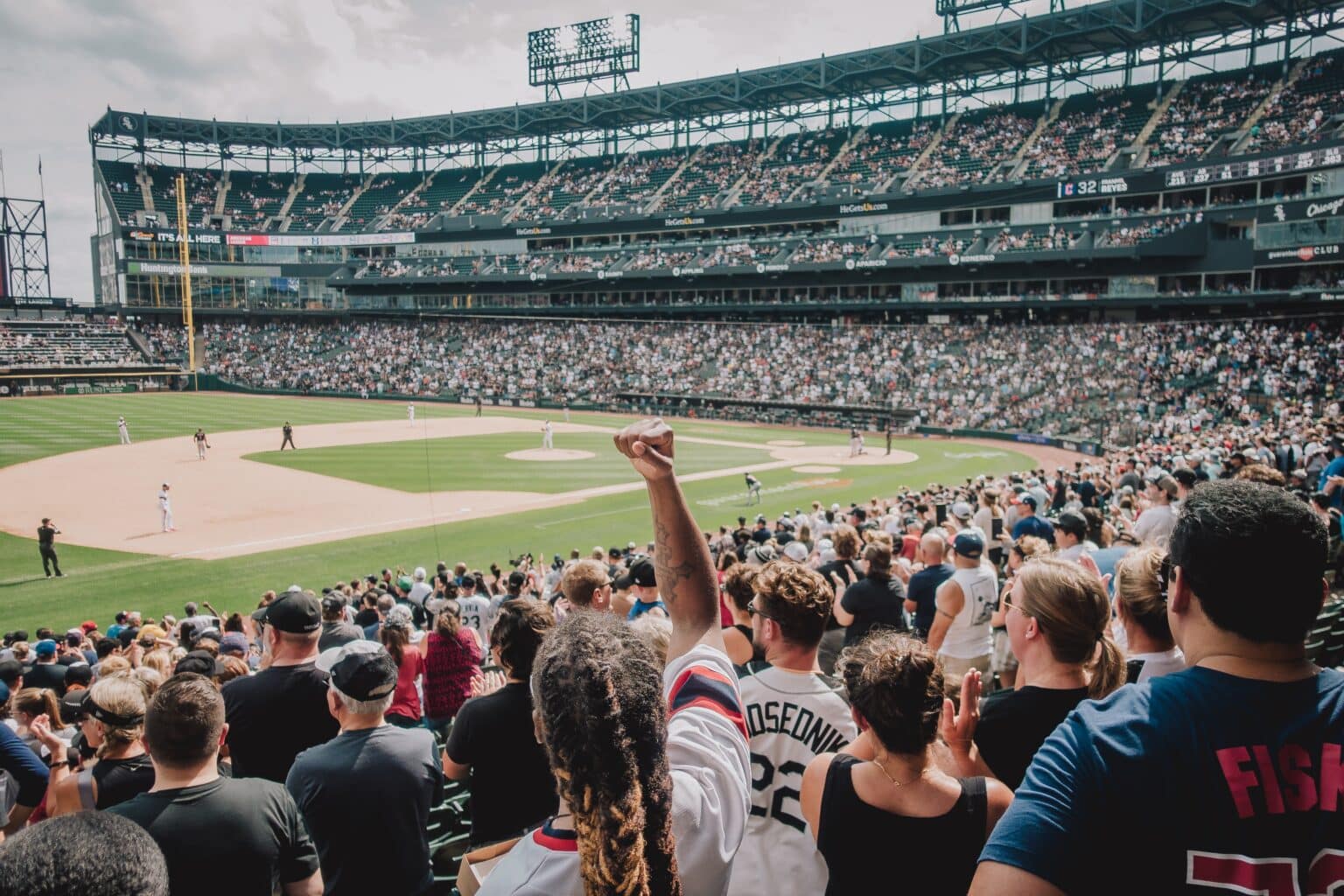 Large crowd cheering at a baseball game.