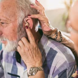 Senior man getting a new hearing aid