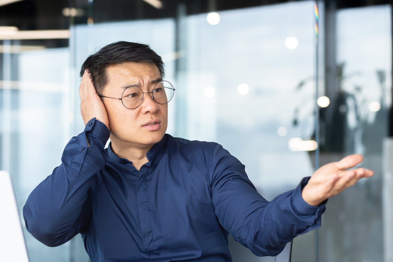 Man quiets someone in an office