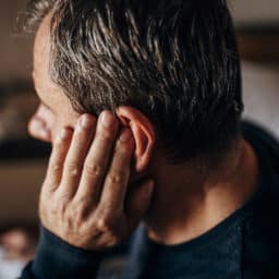 man experiencing hearing aid feedback