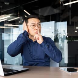 Man at work with tinnitus hushing his coworkers.